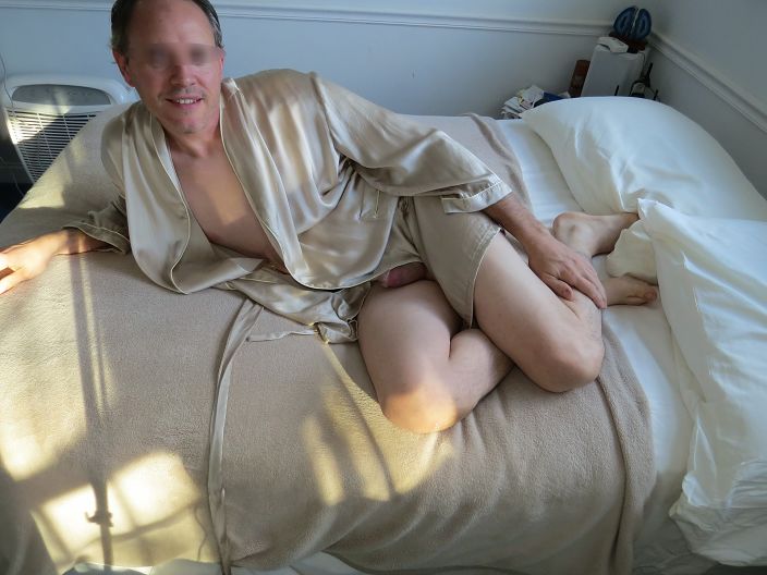 In robe and naked on bed
